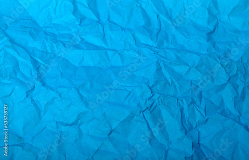 Blue crumpled paper close-up as background or texture