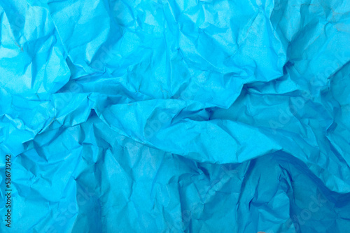 Blue crumpled paper close-up as background or texture