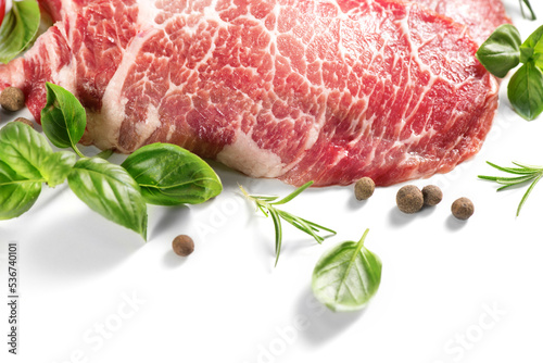 Raw meat isolated on white background. Prime fillet meat. Marble beef steak Black Angus Steak Rib eye with Herbs and Spices.