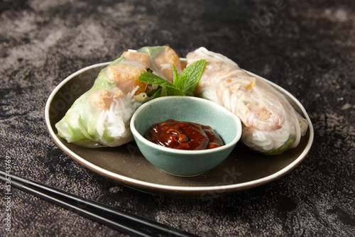 Close up shot of vietnamese fresh spring rolls with dipping sauce photo
