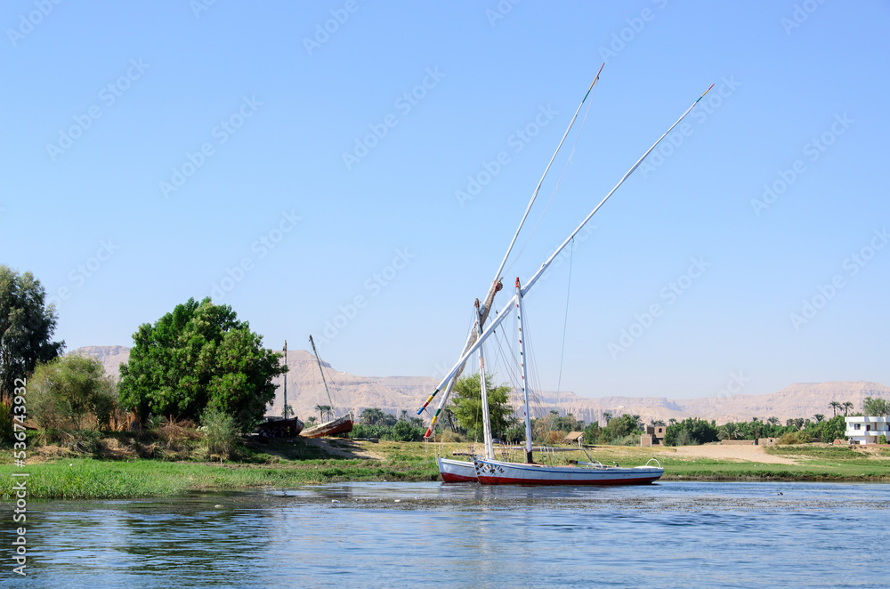 Boats on the Nile River near the city of Luxor on a sunny summer day. Egypt