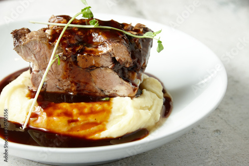 Pork on red sauce and mashed potato