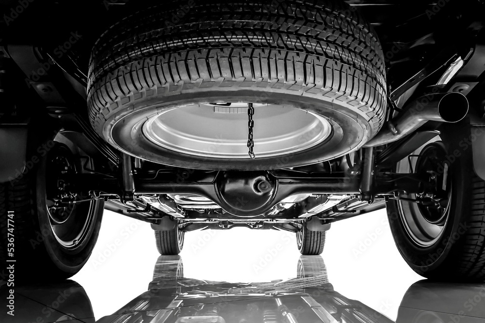 Car suspension, chassis and spare tire on black and white tone. foto de Stock Adobe Stock