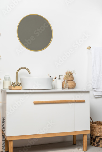 Bathroom marble counter with sink, candles and toothbrushes near white wall, copy space © dark_blade