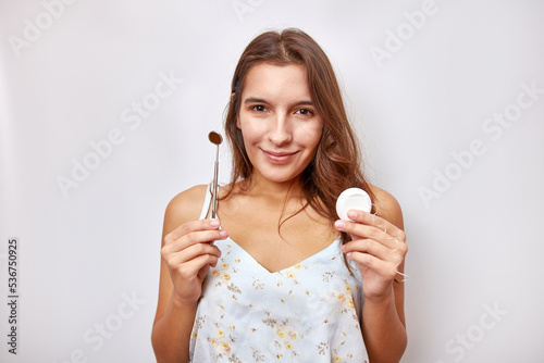 The girl is holding a dental mirror and dental floss. Hygiene and dental care.