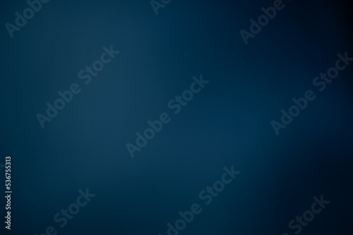 Dark black and blue blurred gradient background has a little abstract light.