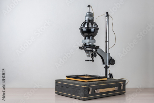 Antique photographic enlarger (1967) with a case as object table.