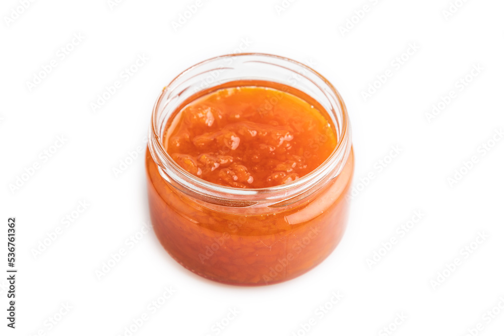 Carrot jam with cinnamon in glass jar isolated on white. Side view. Carrot jam with cinnamon in glass jar isolated on white. Side view.