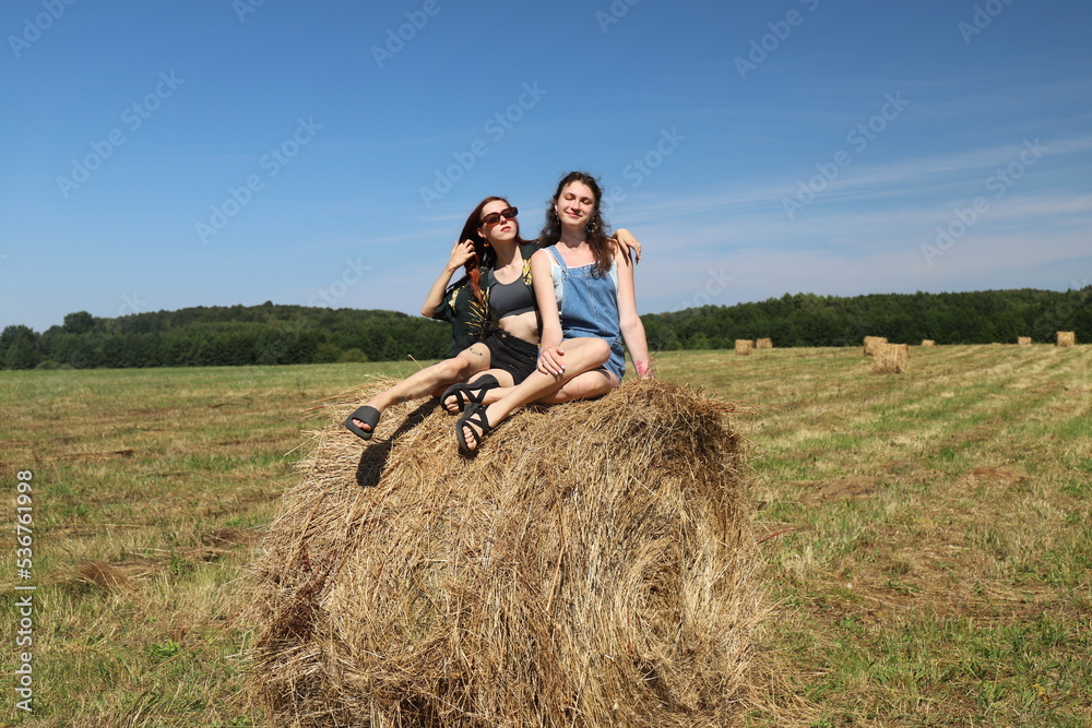 group of friends in a field with a haystack group of friends in a field with a haystack
