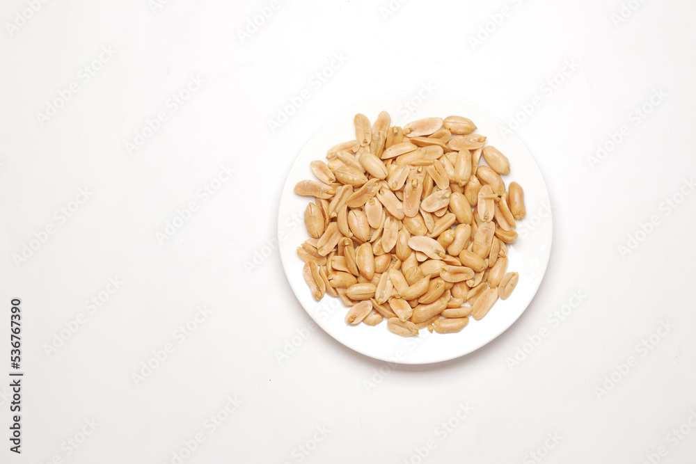 natural peanuts on a plate on white background 