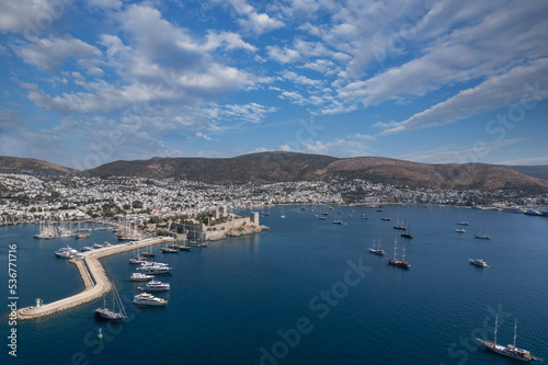 Spectacular view from drone of beautiful yachts filled with Bodrum harbor and ancient citadel in Muğla province of Turkey