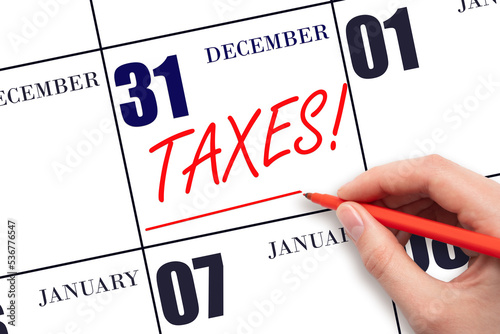 Canvas Print Hand drawing red line and writing the text Taxes on calendar date December 31