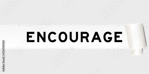 Ripped gray paper background that have word encourage under torn part