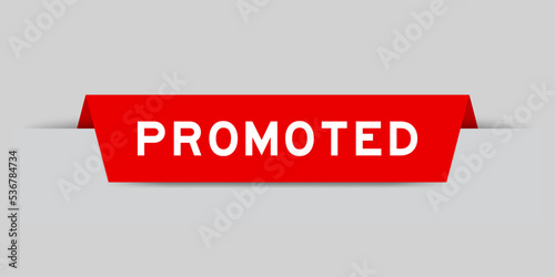Red color inserted label with word promoted on gray background