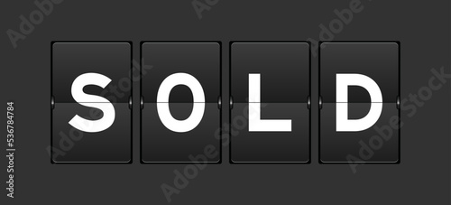 Black color analog flip board with word sold on gray background © bankrx