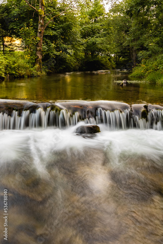 Small waterfall on small river in Golden Mountains at sunny day photo