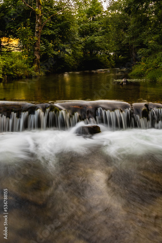 Small waterfall on small river in Golden Mountains at sunny day photo