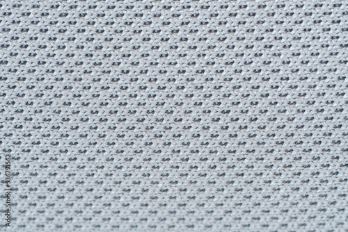 close up macro pattern of knitt soft fiber fabric syntetic modern furniture material weave grey background.