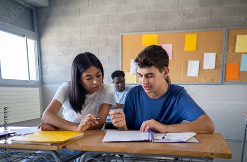 Fotografie Two teenage students working as a team in a class at high school