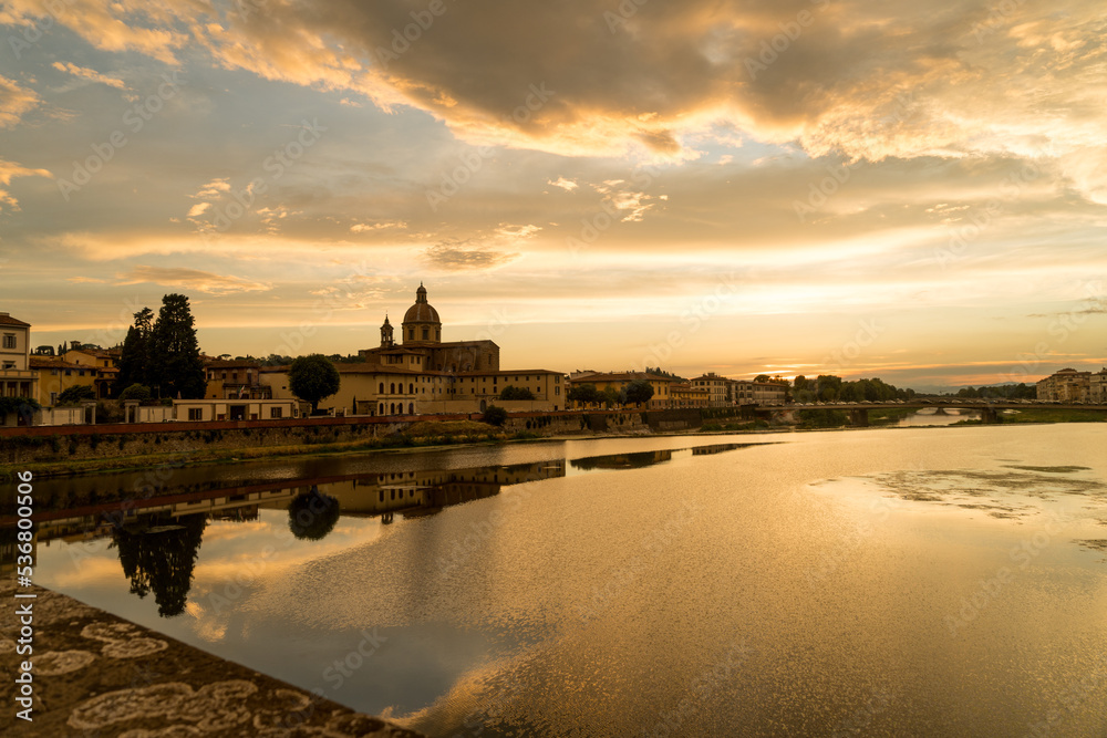 View of Florence city during sunset shot from Bridge over river arno.