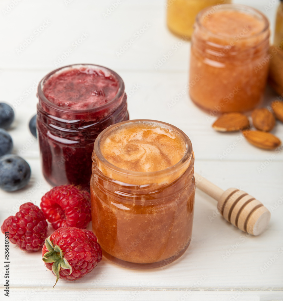 Honey in a glass jar. Raspberry and blueberry honey jam. Remedy for colds and respiratory diseases. Organic product of a vegetarian diet. copy space. copy space Honey in a glass jar. Raspberry and blueberry honey jam. Remedy for colds and respiratory diseases. Organic product of a vegetarian diet. copy space. copy space