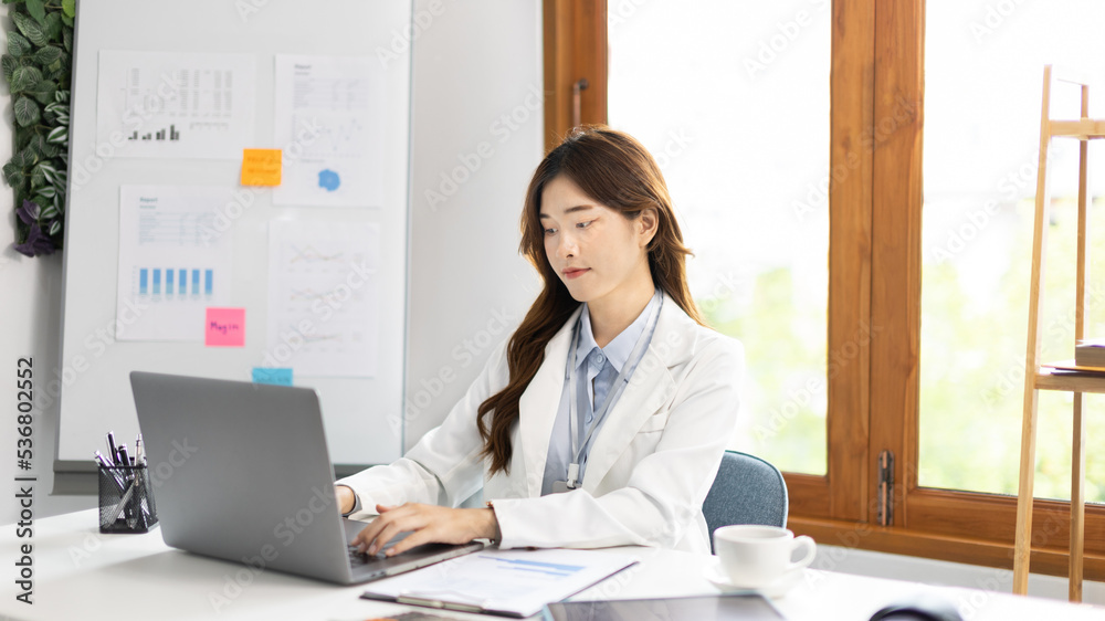 Businesswoman using laptop to work, Asian woman working in the office, Financial clerk or accountant with documents and equipment working on the desk, Using computers for financial transactions. Businesswoman using laptop to work, Asian woman working in the office, Financial clerk or accountant with documents and equipment working on the desk, Using computers for financial transactions.