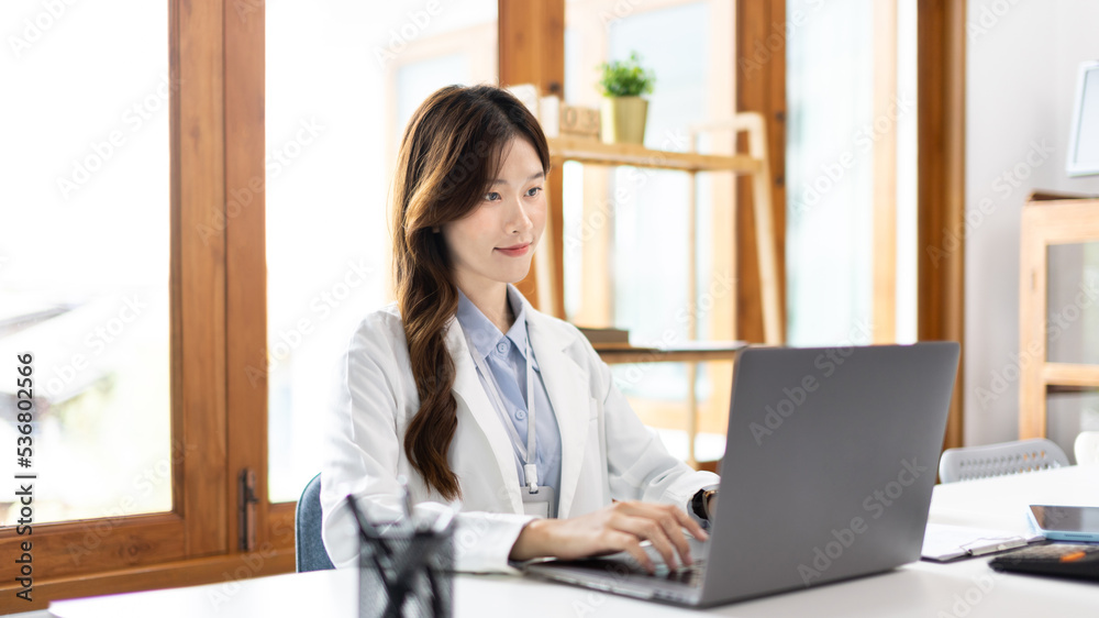 Businesswoman using laptop to work, Asian woman working in the office, Financial clerk or accountant with documents and equipment working on the desk, Using computers for financial transactions. Businesswoman using laptop to work, Asian woman working in the office, Financial clerk or accountant with documents and equipment working on the desk, Using computers for financial transactions.