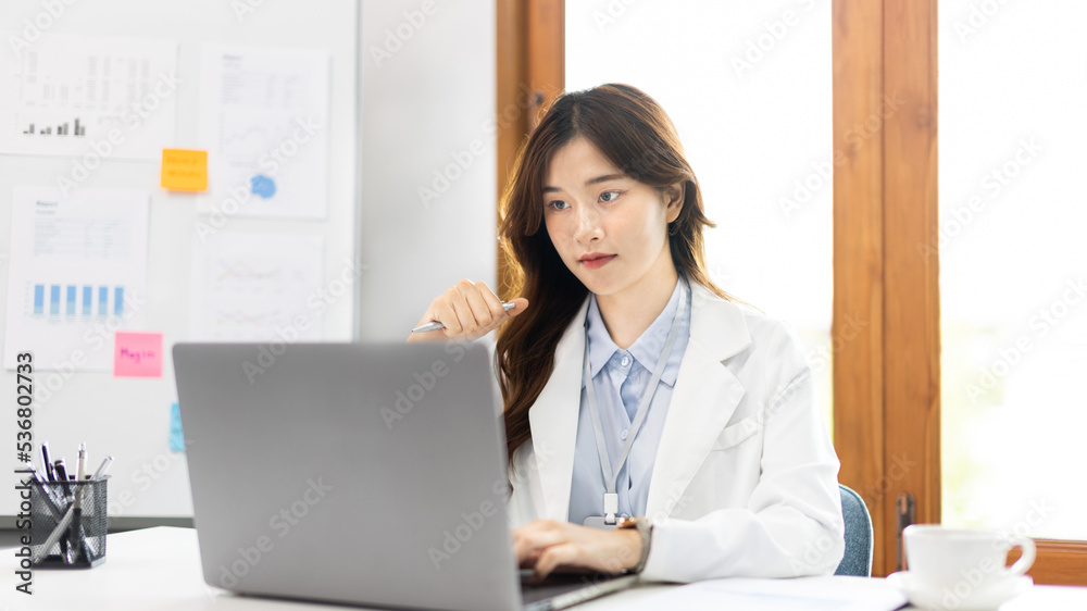Businesswoman using laptop to work, Asian woman working in the office, Financial clerk or accountant with documents and equipment working on the desk, Using computers for financial transactions. Businesswoman using laptop to work, Asian woman working in the office, Financial clerk or accountant with documents and equipment working on the desk, Using computers for financial transactions.