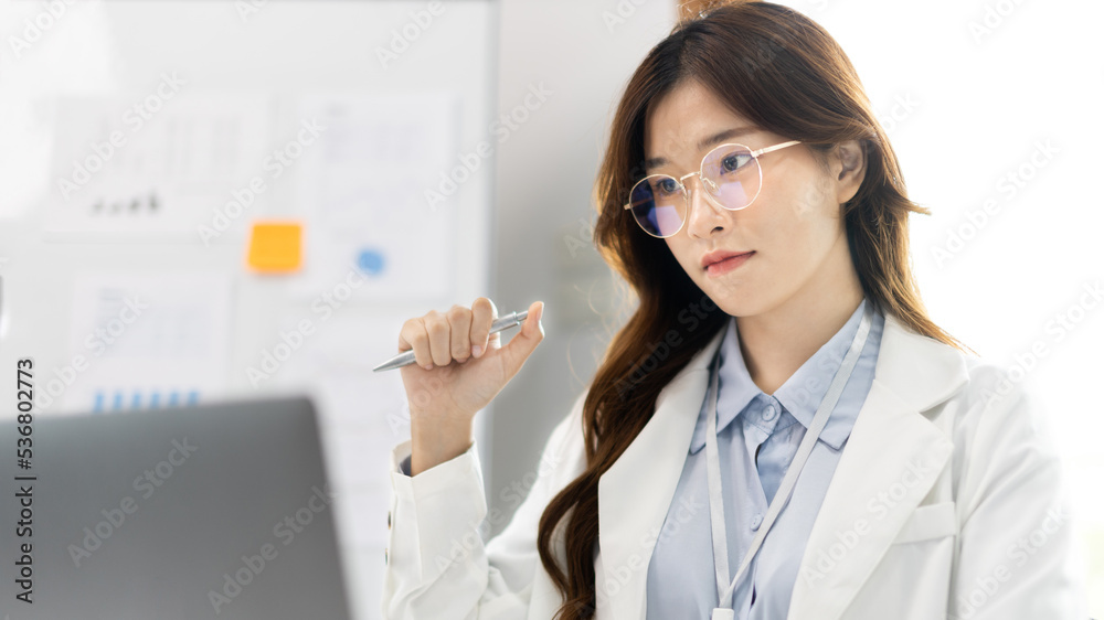 Businesswoman using laptop to work, Asian woman working in the office, Financial clerk or accountant with documents and equipment working on the desk, Using computers for financial transactions. Businesswoman using laptop to work, Asian woman working in the office, Financial clerk or accountant with documents and equipment working on the desk, Using computers for financial transactions.