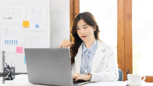 Businesswoman using laptop to work, Asian woman working in the office, Financial clerk or accountant with documents and equipment working on the desk, Using computers for financial transactions.