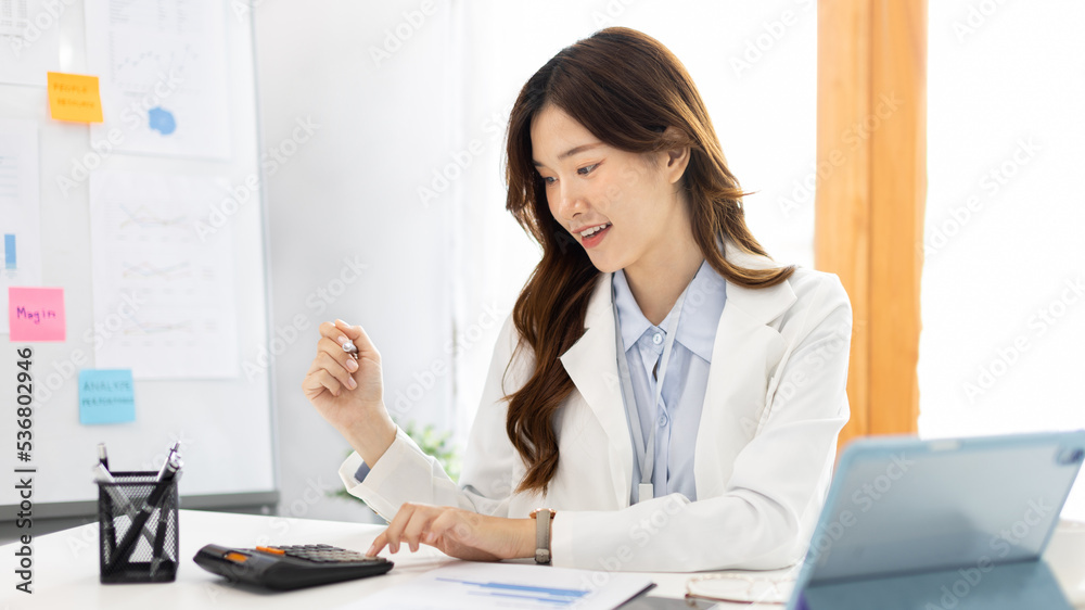 Asian business women are analyzing graphs, Financial statistics and calculating corporate returns in private offices, Market research reports and income statistics, Financial and Accounting concept. Asian business women are analyzing graphs, Financial statistics and calculating corporate returns in private offices, Market research reports and income statistics, Financial and Accounting concept.