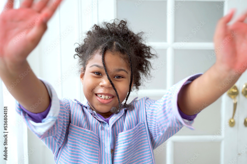 Hispanic little girl showing a beautiful smile and waves her hand to camera. Hispanic little girl showing a beautiful smile and waves her hand to camera.