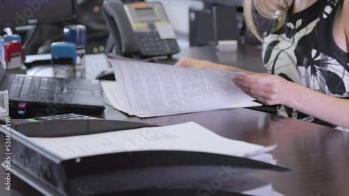 A business woman is given documents to sign. Hands of a woman signing a contract. Close-up