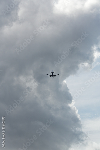 Airplane landing with storm clouds in background