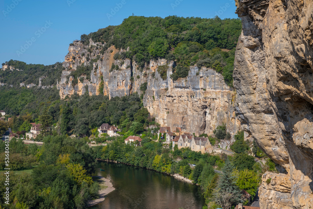 the rocks in the dordogne area with the river and old houses