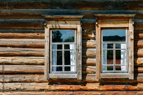 Two windows in a wooden log house