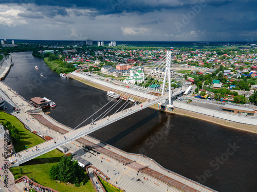 Russia, Tyumen - June 12, 2022: Tyumen city, Tura river embankment, bridge of lovers. aerial photography