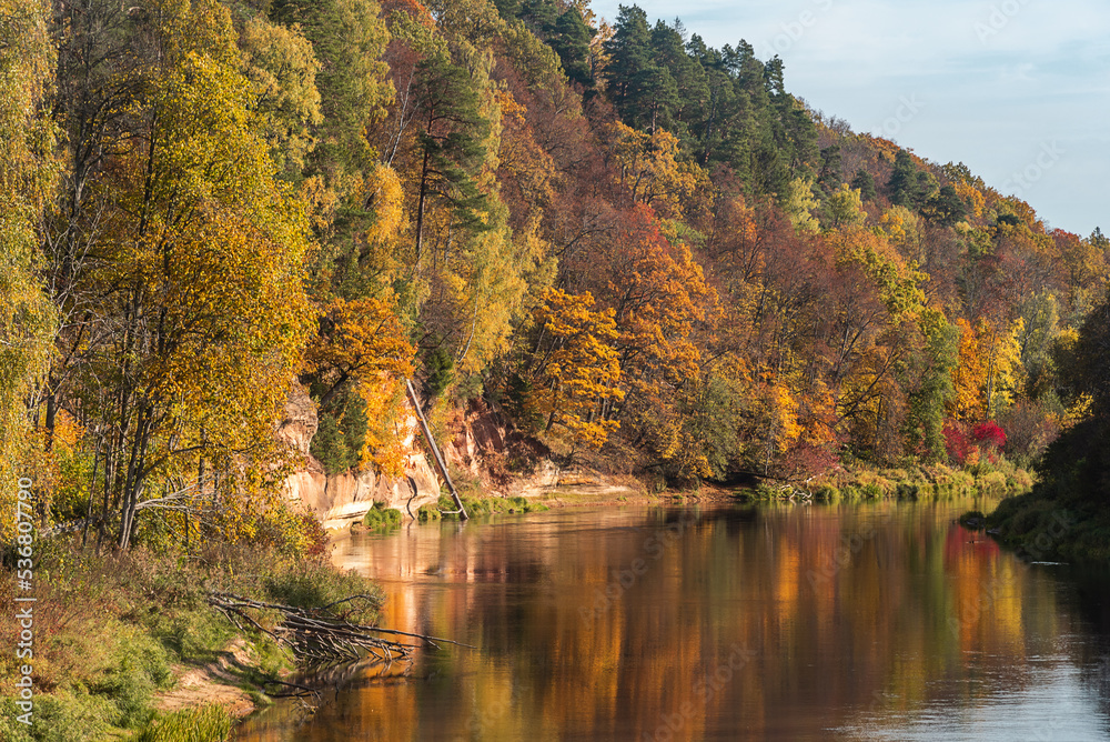 Landscape view of red sandstone caves on Gauja river in Sigulda, Latvia on a autumn day Landscape view of red sandstone caves on Gauja river in Sigulda, Latvia on a autumn day