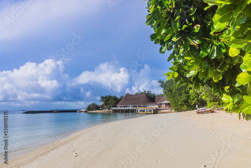Tropical sand beach and blue sky with white clouds in the Maldives