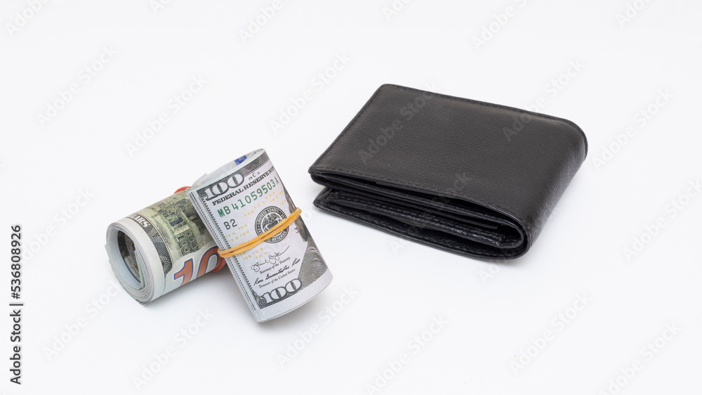 Hundred dollar bills rolled up with rubber band on isolated white background Hundred dollar bills rolled up with rubber band on isolated white background