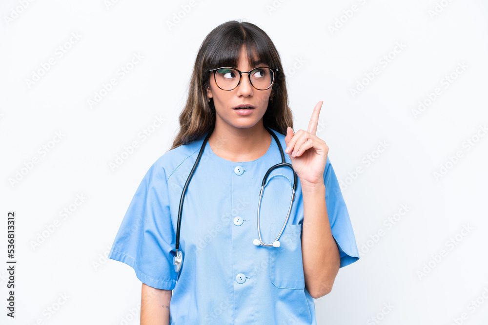 Young caucasian nurse woman isolated on white background thinking an idea pointing the finger up Young caucasian nurse woman isolated on white background thinking an idea pointing the finger up