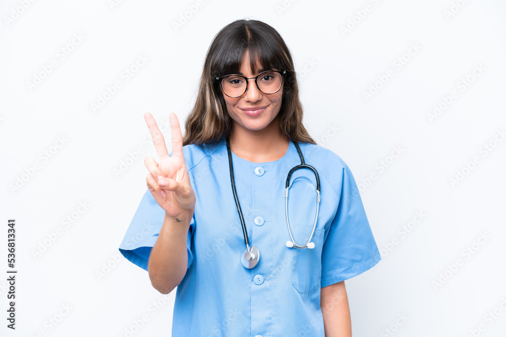 Young caucasian nurse woman isolated on white background smiling and showing victory sign Young caucasian nurse woman isolated on white background smiling and showing victory sign