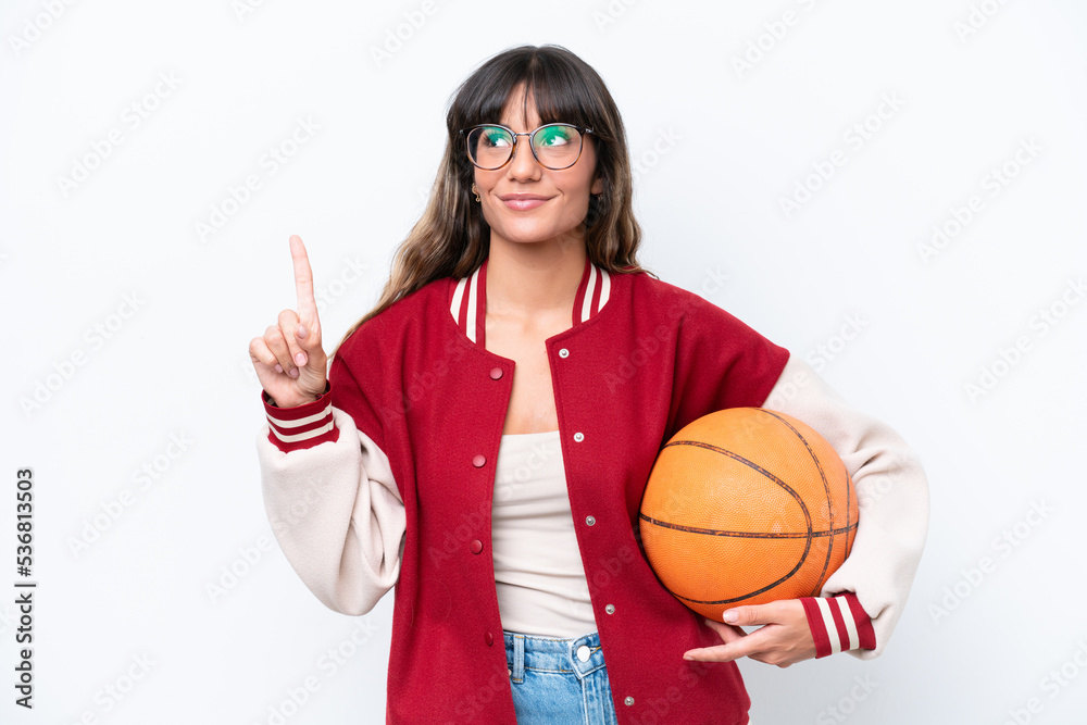 Young caucasian woman playing basketball isolated on white background pointing up a great idea Young caucasian woman playing basketball isolated on white background pointing up a great idea
