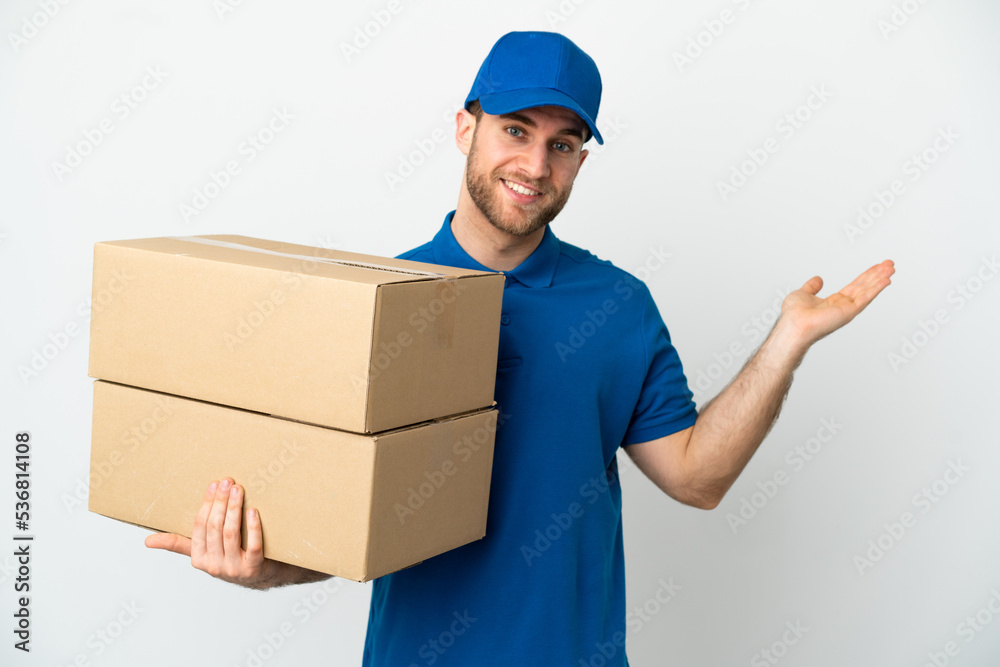 Delivery man over isolated white background extending hands to the side for inviting to come Delivery man over isolated white background extending hands to the side for inviting to come