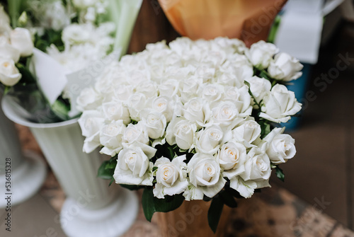 A beautiful bouquet, a lot of white roses stands in a vase close-up. Photography of nature.