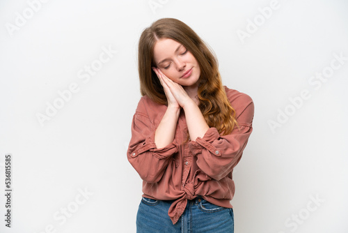 Young pretty woman isolated on white background making sleep gesture in dorable expression