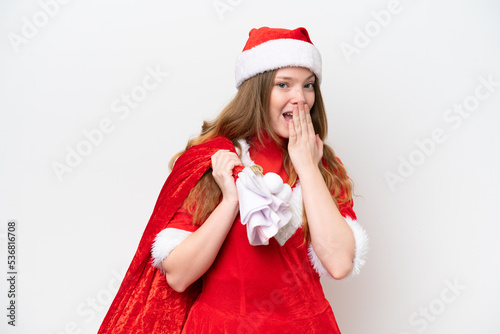 Young caucasian woman with Christmas dress holding Christmas sack isolated on white background with surprise and shocked facial expression