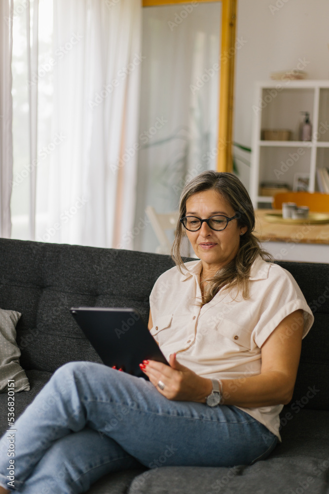 Adult woman having video call at home using tablet Adult woman having video call at home using tablet