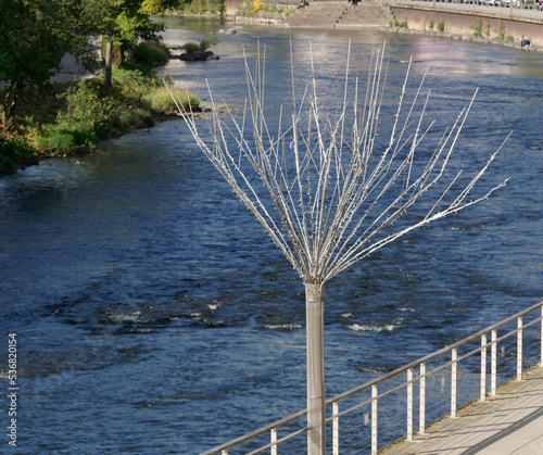 Many wire trees stand by the river Lenne in Altena. photo