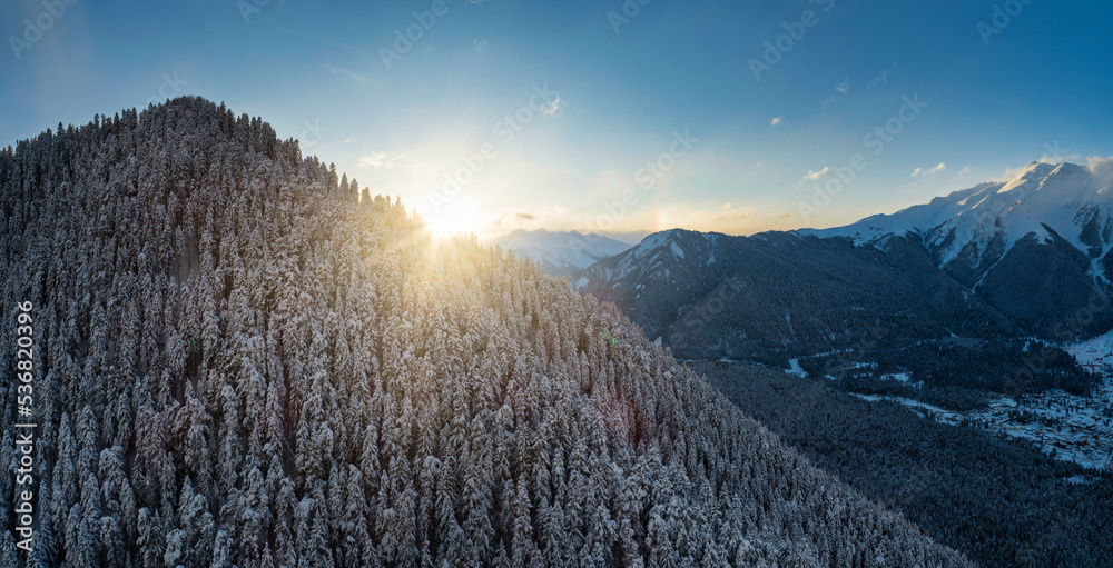 Panoramic aerial view of the sun setting over the mountains